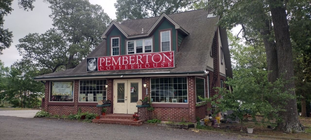 Pemberton Coffeehouse front entrance — brick steps, white double doors, central sign on a green dormer